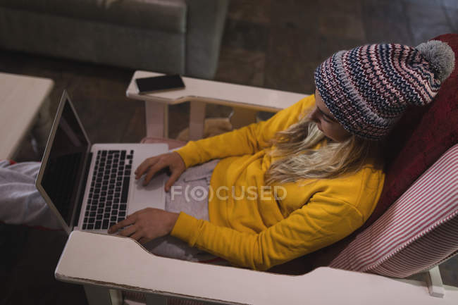 Girl using laptop in living room at home — Stock Photo