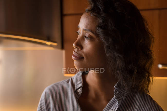 Thoughtful woman relaxing at home — Stock Photo