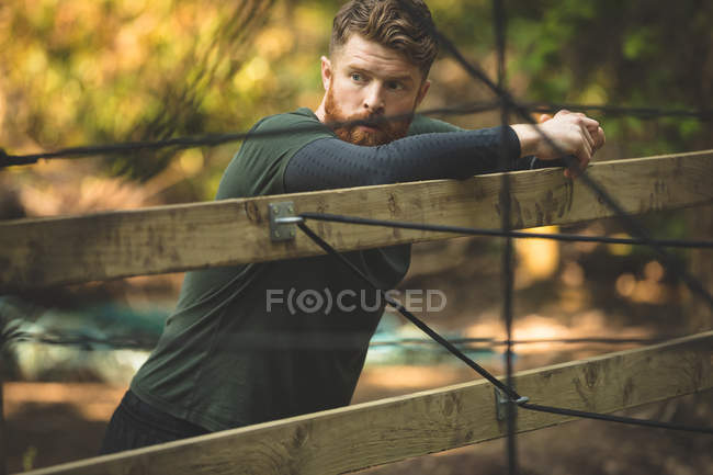 Fit man taking break at boot camp on a sunny day — Stock Photo