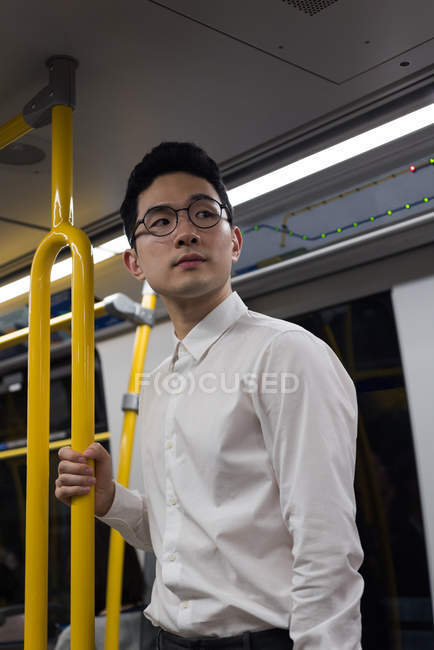 Thoughtful man travelling in train — Stock Photo