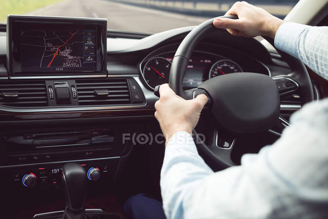 Businessman driving a modern car — Stock Photo