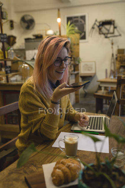 Junge Frau mit Handy im Café — Stockfoto