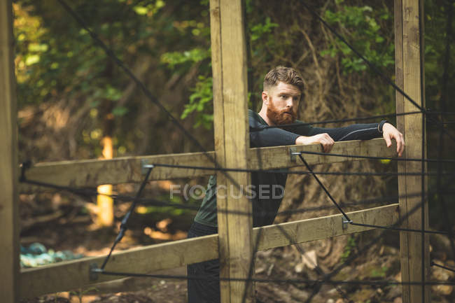 Fit man taking break at boot camp on a sunny day — Stock Photo