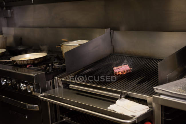 Meat cooking in barbecue at restaurant — Stock Photo