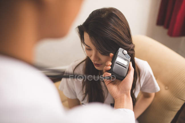 Female photographer recording an interview using voice recorder — Stock Photo