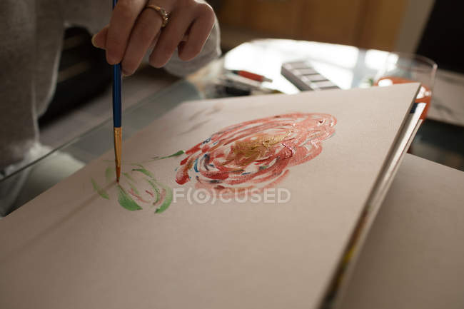 Mid section of woman coloring a sketch at home — Stock Photo