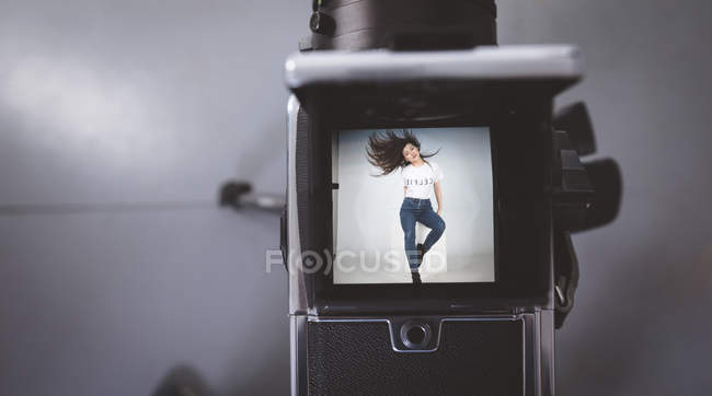 Close-up of models picture on digital camera in photo studio — Stock Photo