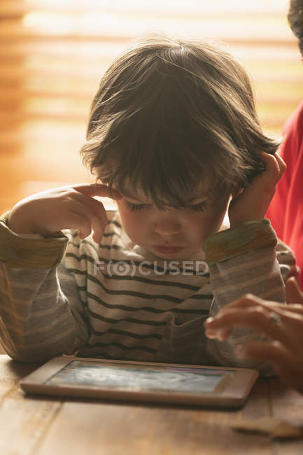 Мальчик смотрит на скрижаль дома — стоковое фото