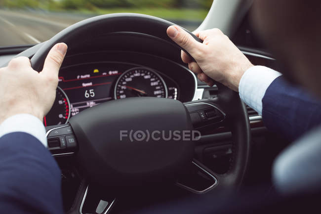 Businessman driving a modern car — Stock Photo
