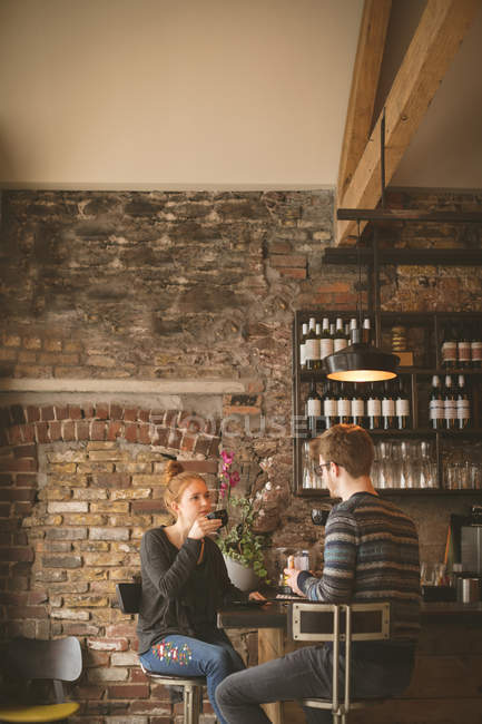 Jovem casal tomando café no balcão do bar — Fotografia de Stock
