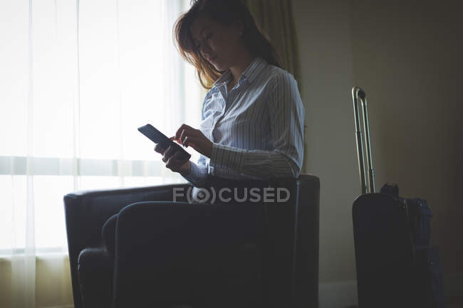Businesswoman using digital tablet in hotel room — Stock Photo