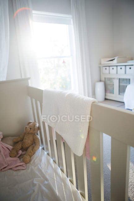 Wooden cradle with soft toy at home — Stock Photo