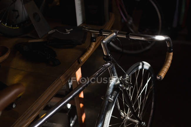 Close-up of racing bicycle in workshop — Stock Photo