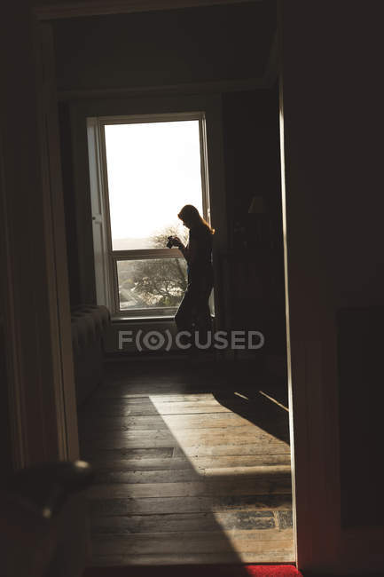 Женщина смотрит на фото в камеру дома — стоковое фото