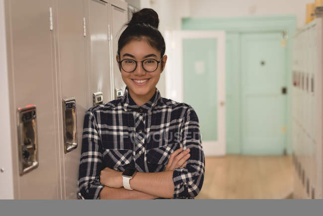 Portrait of smiling female executive standing with arm crossed in the locker room — Stock Photo