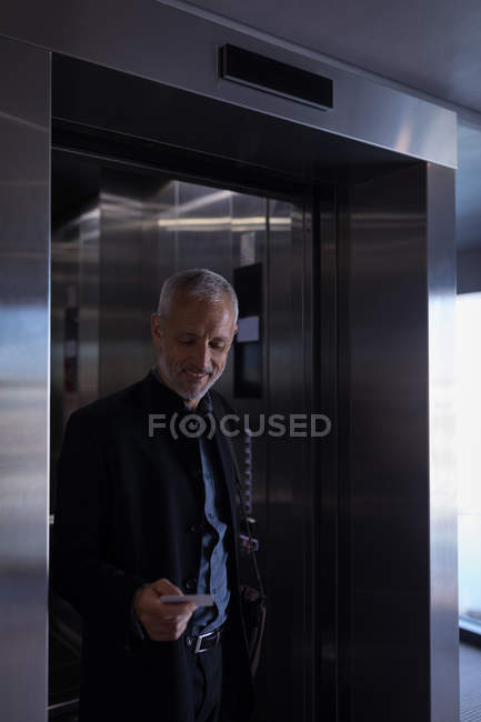Businessman walking out the elevator in a hotel — Stock Photo