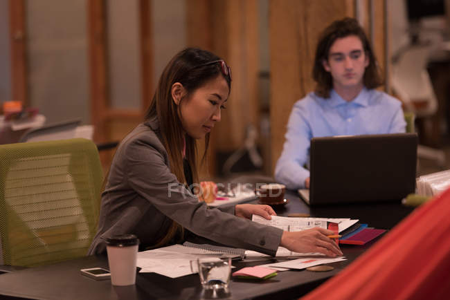 Business colleagues working at desk in office. — Stock Photo