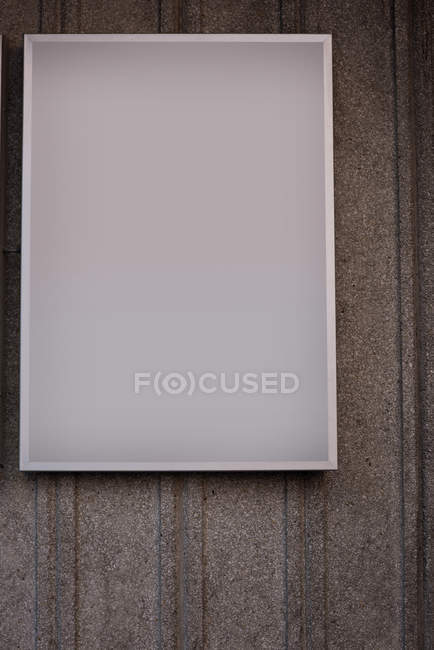 Close-up of blank advertisement board on concrete background — Stock Photo