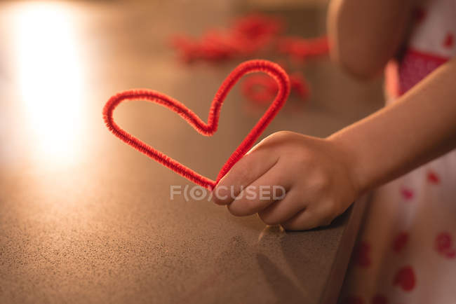Close-up of girl preparing heat shape decoration at home — Stock Photo