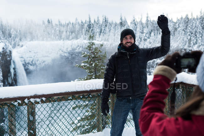 Woman taking photo of man with camera during winter — Stock Photo