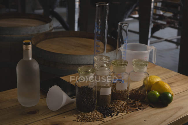 Lemon and spices ingredients on table in gin factory — Stock Photo