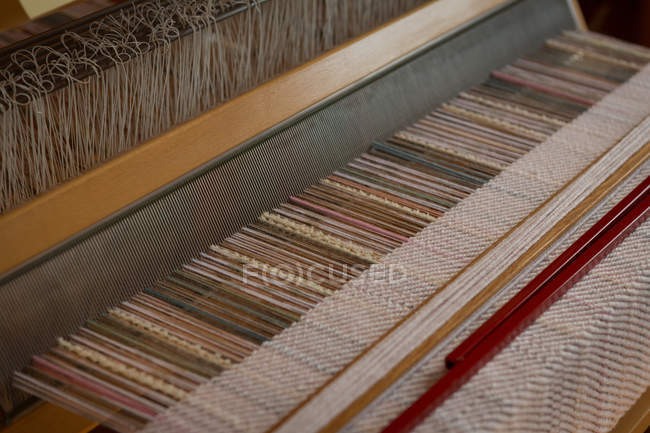 Close-up of machine with silk thread in factory — Stock Photo