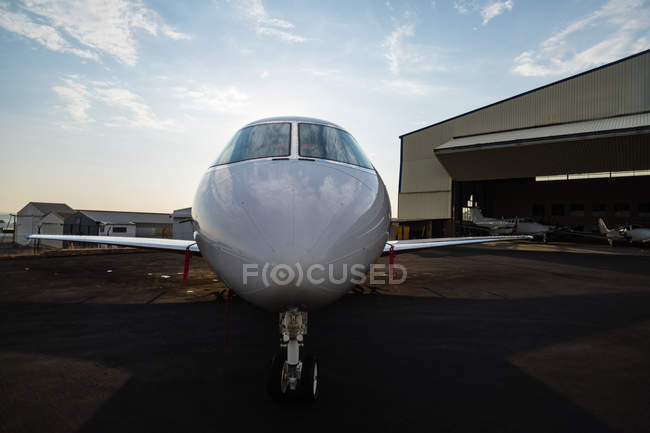 Private jet at terminal in sunlight — Stock Photo
