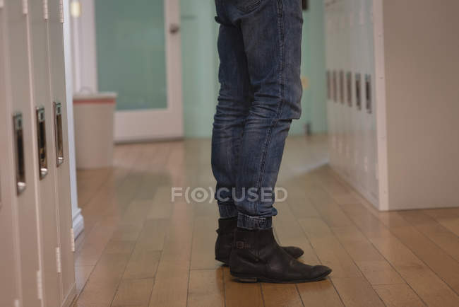 Male executive standing on wooden floor in creative office — Stock Photo