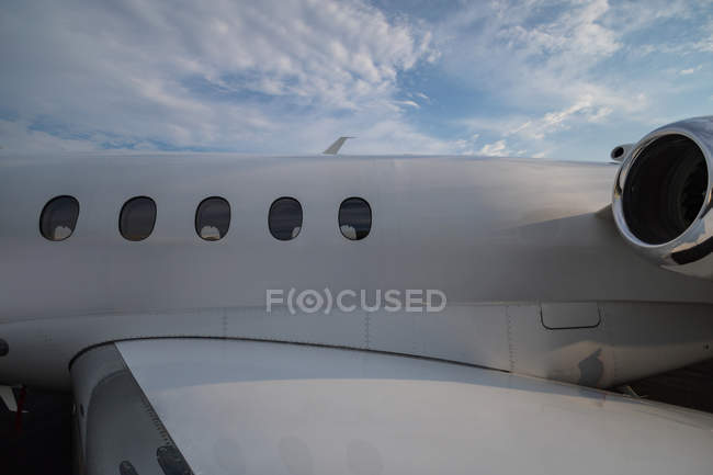 Private jet with part of wing and at terminal — Stock Photo