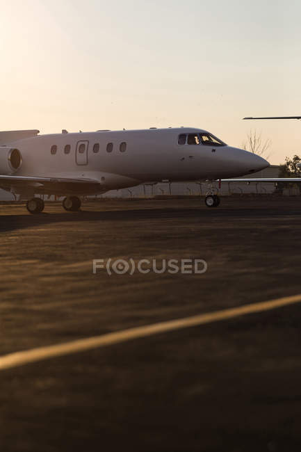 Private jet on runaway at dusk — Stock Photo