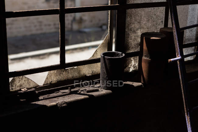 Two rusty containers kept on the window sill at scrapyard — Stock Photo