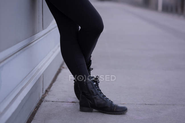 Low section of woman standing in city street — Stock Photo