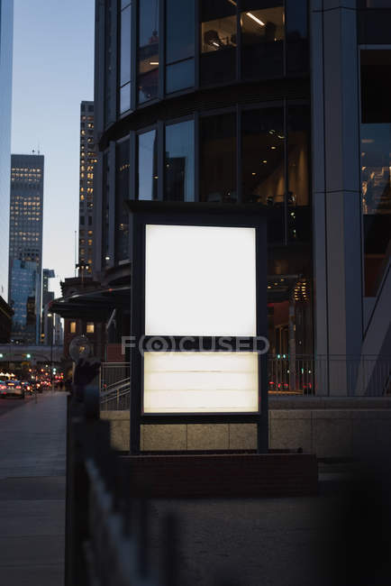 Blank advertisement board near street at night — Stock Photo