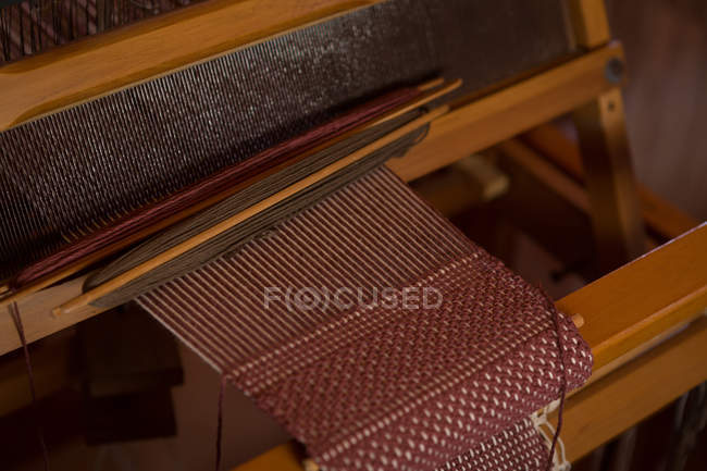 Close-up of machine with silk thread in factory — Stock Photo