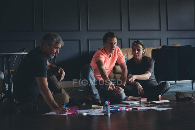 Business colleagues discussing over documents in office — Stock Photo