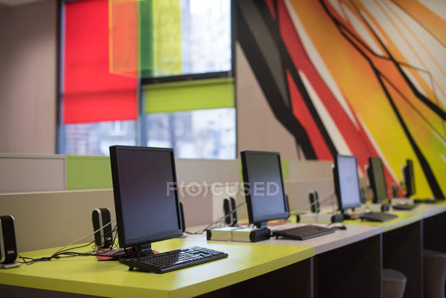 Various desktop pc in library — Stock Photo