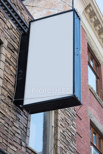 Low angle blank advertisement board near street on a sunny day — Stock Photo