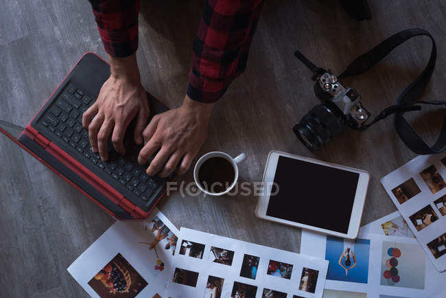 Male executive using laptop in office — Stock Photo