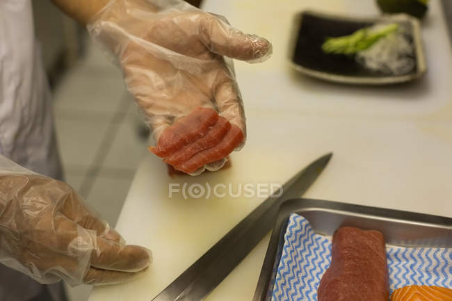 Senior chef preparing sushi in kitchen at hotel — Stock Photo