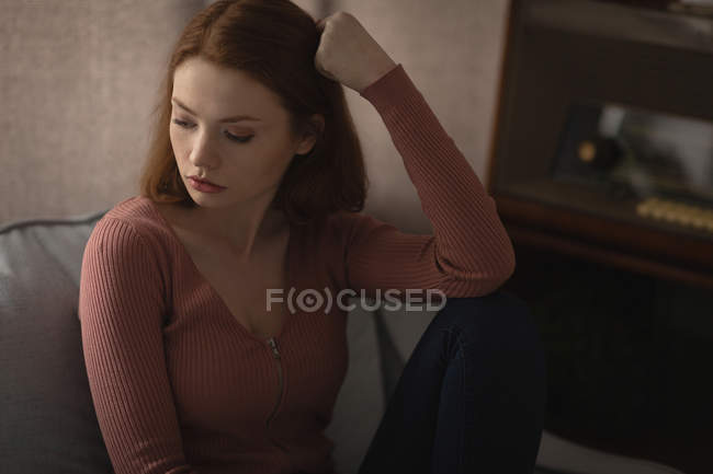 Thoughtful woman relaxing at home — Stock Photo