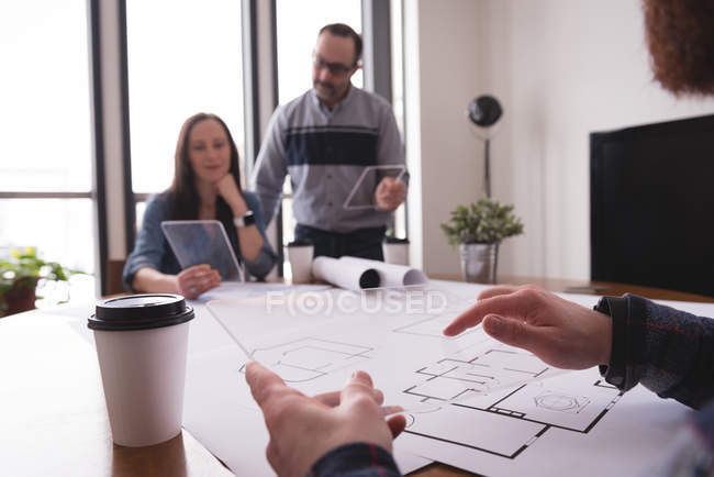 Business colleagues using glass digital tablet in office — Stock Photo