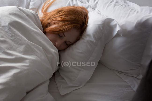 Woman sleeping in bedroom at home — Stock Photo