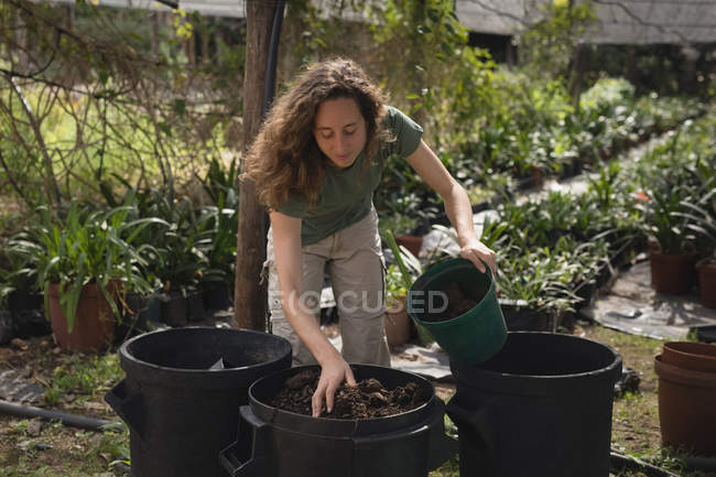 Agricoltore che prepara il terreno in secchio a serra — Foto stock