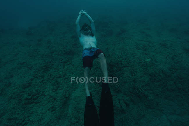 Man snorkeling underwater in sea water — Stock Photo