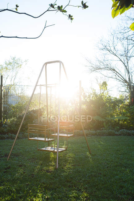 Leere Schaukel im Garten an einem sonnigen Tag — Stockfoto