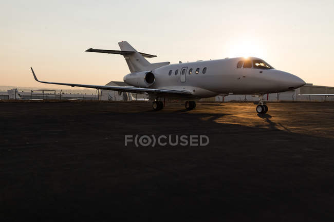 Private jet at terminal during dusk — Stock Photo