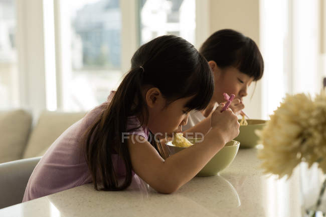 Adorable siblings having breakfast at home — Stock Photo