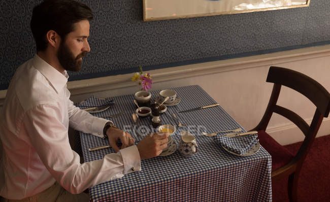 Caucasian handsome groom having tea at home — Stock Photo