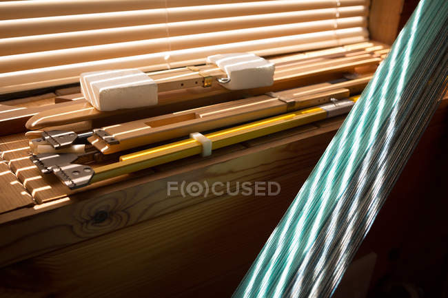 Close-up of weaving equipment kept on table — Stock Photo