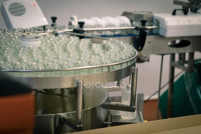 Empty glass jars on production line in the food factory — Stock Photo